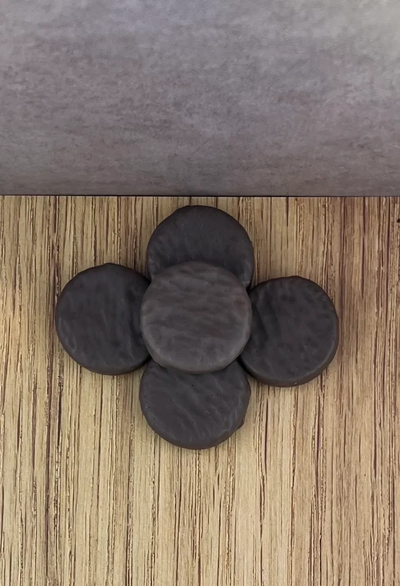 A wooden floor with some black coins on it