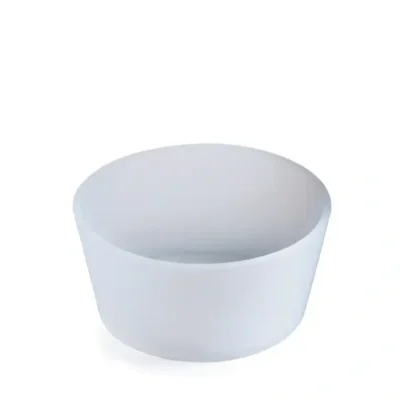 A white bowl is sitting on the floor.