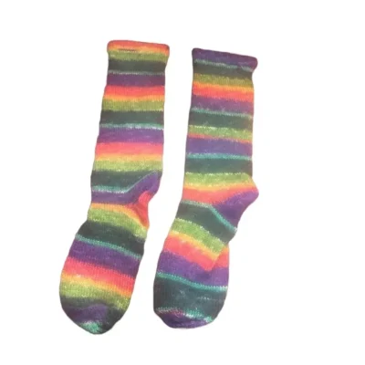 A pair of rainbow socks sitting on top of a table.