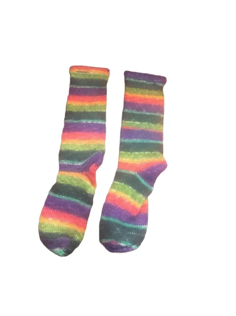 A pair of rainbow socks sitting on top of a table.