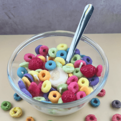 A bowl of colorful cereal with a spoon.